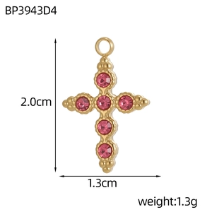 Macro detail of gold-plated cross pendant with six pink zircons and bead edging
