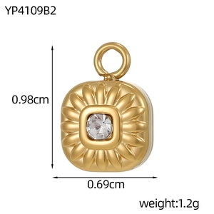 Macro detail of a gold envelope cross pendant with center diamond and size annotations