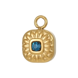 Detail of gold-plated sunflower pendant featuring a radiant blue gemstone center
