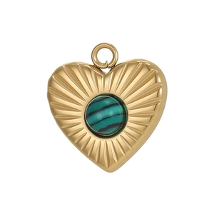 Detailed macro view of a golden heart pendant with malachite stone inlay and radial texture
