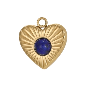 Detail of heart pendant with radiant texture and blue lapis stone in gold finish