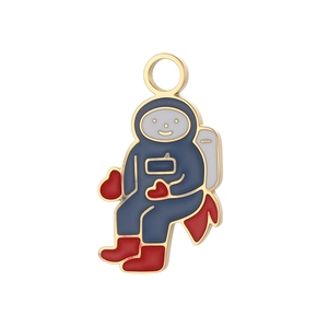 Detail of golden astronaut charm with navy enamel and red heart for DIY jewelry