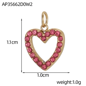 Macro shot of gold heart pendant with pink crystals and dimensions 1.1cm x 1.0cm