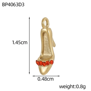 Macro shot of gold high heel pendant with red rhinestones and dimensional markings