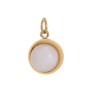 Detailed macro view of a sunburst pendant with a translucent white stone and gold plating