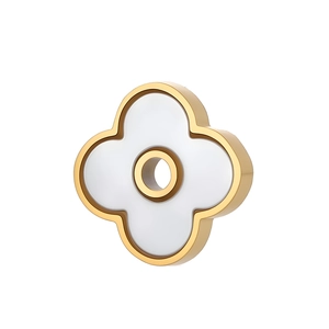 Colgante trébol de acero inoxidable chapado en oro con nácar blanco sobre fondo blanco