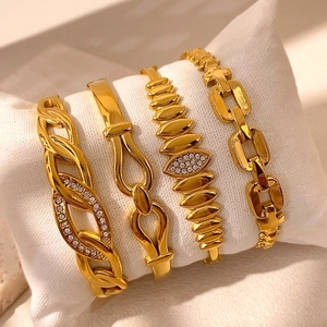 Set di quattro bracciali a catena dorati e rigidi con fibbie equestri e cristalli