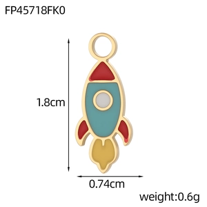 Detail view of colorful enamel rocket pendant with 1.8cm height and 0.74cm width dimensions