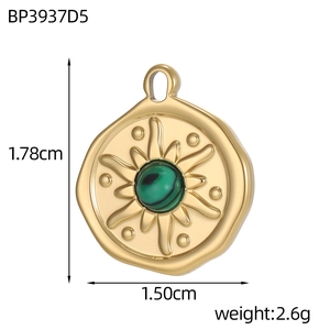 Detailed view of a gold sunburst pendant with a green malachite center stone inlay