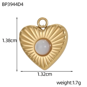 Macro shot of heart-shaped gold pendant with sunburst texture and pearl inlay dimensions