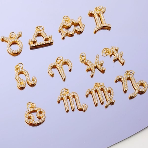 Macro shot of gold-plated twelve zodiac pendants with shimmering micro-pave crystals