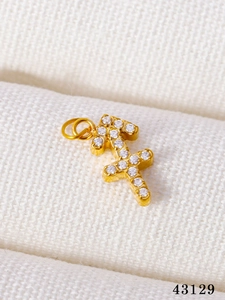 Macro shot of gold-plated Sagittarius pendant with sparkling white cubic zirconia