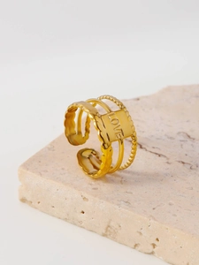 Detail of gold-plated multi-layer ring featuring a LOVE engraving and adjustable open design