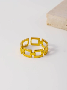 Detailed macro shot of a gold-plated stainless steel hollow rectangular chain link ring