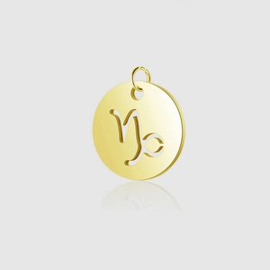 Detail macro of hollow Capricorn zodiac pendant in gold-plated stainless steel with ring