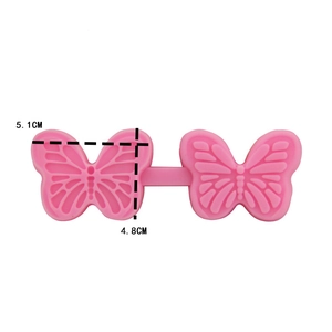 Detail view of pink silicone butterfly mold with size markers 5.1cm and 4.8cm