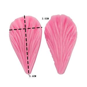 Macro view of food-grade pink silicone fondant mold featuring detailed leaf vein textures