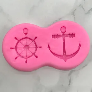 Pink silicone mold featuring detailed anchor and helm designs for DIY fondant and resin craft