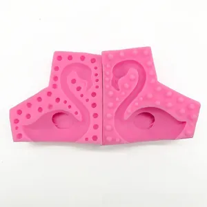 Detailed macro view of a flexible pink silicone mold showing the swan shape structure
