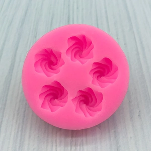 Macro shot of rose flower shapes in a pink silicone mold for chocolate and fondant DIY