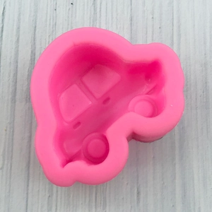 Close-up of pink car-shaped silicone mold showing detailed windows and wheels for DIY baking