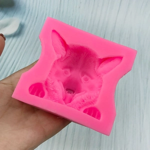 Pink silicone mold featuring detailed dog head texture for chocolate and fondant making
