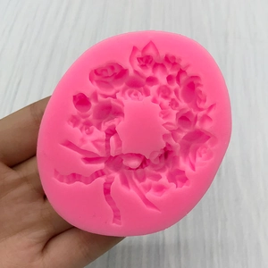 Pink silicone mold featuring detailed rose floral wreath patterns for DIY cake fondant