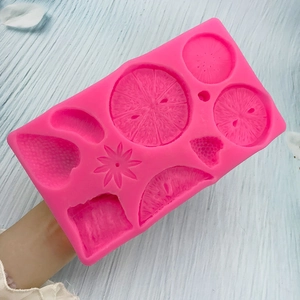Pink silicone fruit mold for strawberry and orange fondant cake decorations