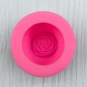 Top view of pink silicone mold with detailed rose flower texture for candle making