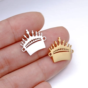 Macro shot of mirror polished crown pendants in gold and silver for DIY jewelry