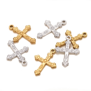 Detailed view of vintage engraved cross pendants in gold and silver for DIY jewelry