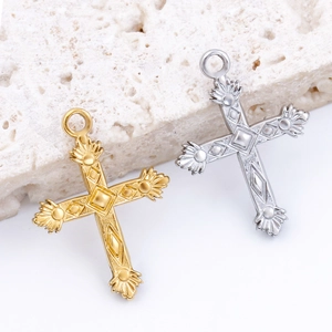 Cross pendants in gold and silver steel with geometric relief on stone surface