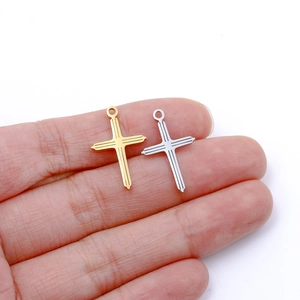 Dettaglio di piccoli pendenti a croce in acciaio inossidabile oro e argento per gioielli DIY