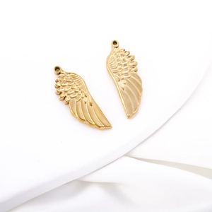 Detailed close-up of matte gold angel wing pendants with realistic feather textures