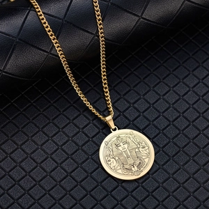 Detailed view of golden Egyptian pharaoh Tutankhamun pendant on black leather