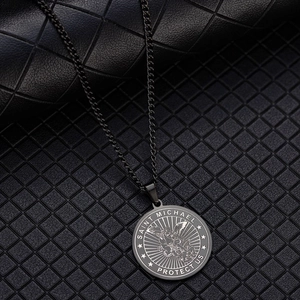 Close-up of Saint Michael Archangel engraving on a matte black stainless steel medal necklace