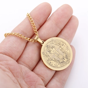 Detail shot of golden circular pendant featuring Egyptian Pharaoh relief carving