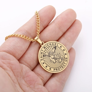 Detailed close-up of golden Saint Michael protect us archangel pendant necklace