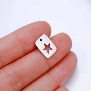 Polished stainless steel rectangular pendant with hollow star held between fingertips