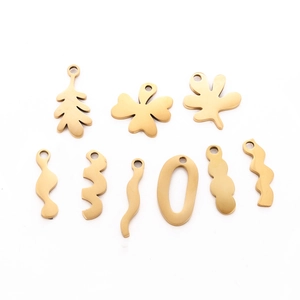 Macro shot of 9 gold-plated irregular leaf and wave charms for DIY jewelry making