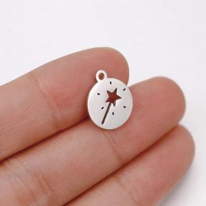 Close-up of a mirror-polished stainless steel fairy wand charm with star cutout detail