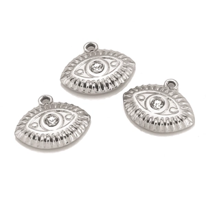 Detailed view of three stainless steel evil eye pendants with sparkling cubic zirconia