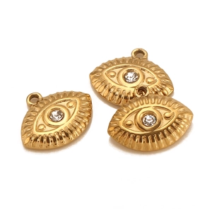 Detailed view of three 18K gold-plated stainless steel evil eye charms with cubic zirconia