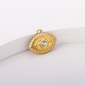 Detail view of 18K gold plated evil eye pendant with crystal inlay on a stone stand