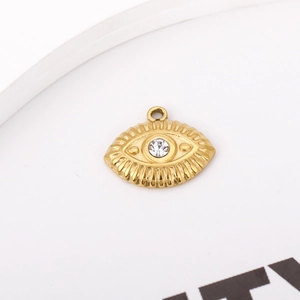 Macro shot of 18K gold plated evil eye pendant with cubic zirconia and engraved details