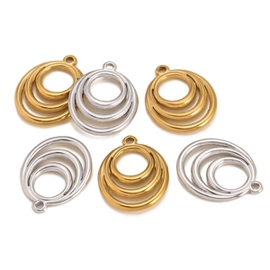 Detail view of triple-layered geometric round circle charms in gold and silver finish