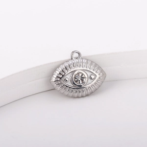 Macro shot of silver evil eye pendant with sparkling zircon set in stainless steel