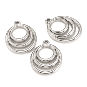 Macro detail of multi-layer circular stainless steel pendants for DIY jewelry making