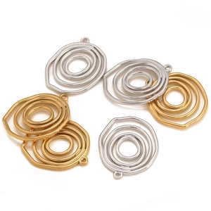 Detail of round hollow concentric gold and silver plated stainless steel jewelry charms