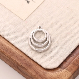 Macro detail of triple-layered stainless steel circles pendant for DIY jewelry making
